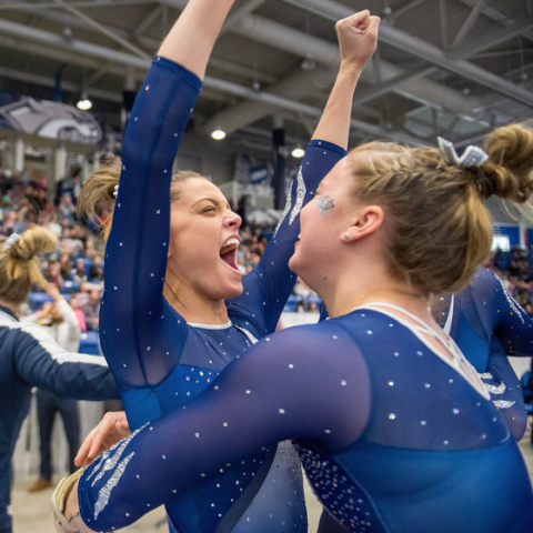 UNH gymnasts celebrating a win